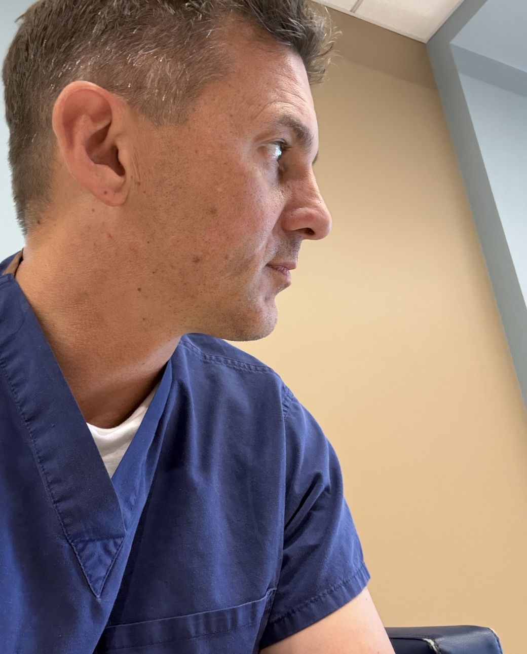 Brian Wallace, PA-C, in navy scrubs